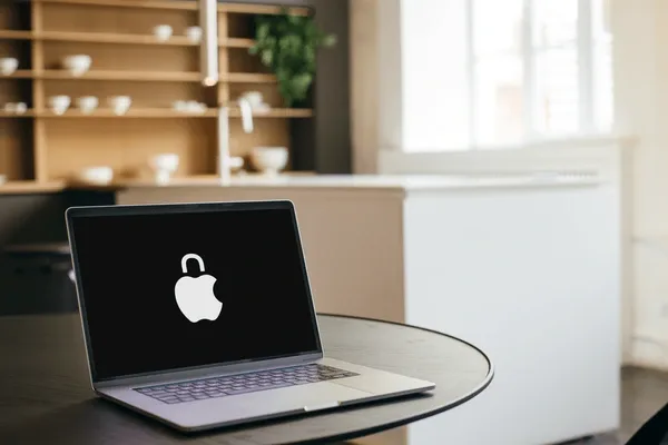 The MacBook features a redesigned Apple logo in the style of a lock. 